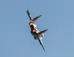 A military aircraft flying in the sky