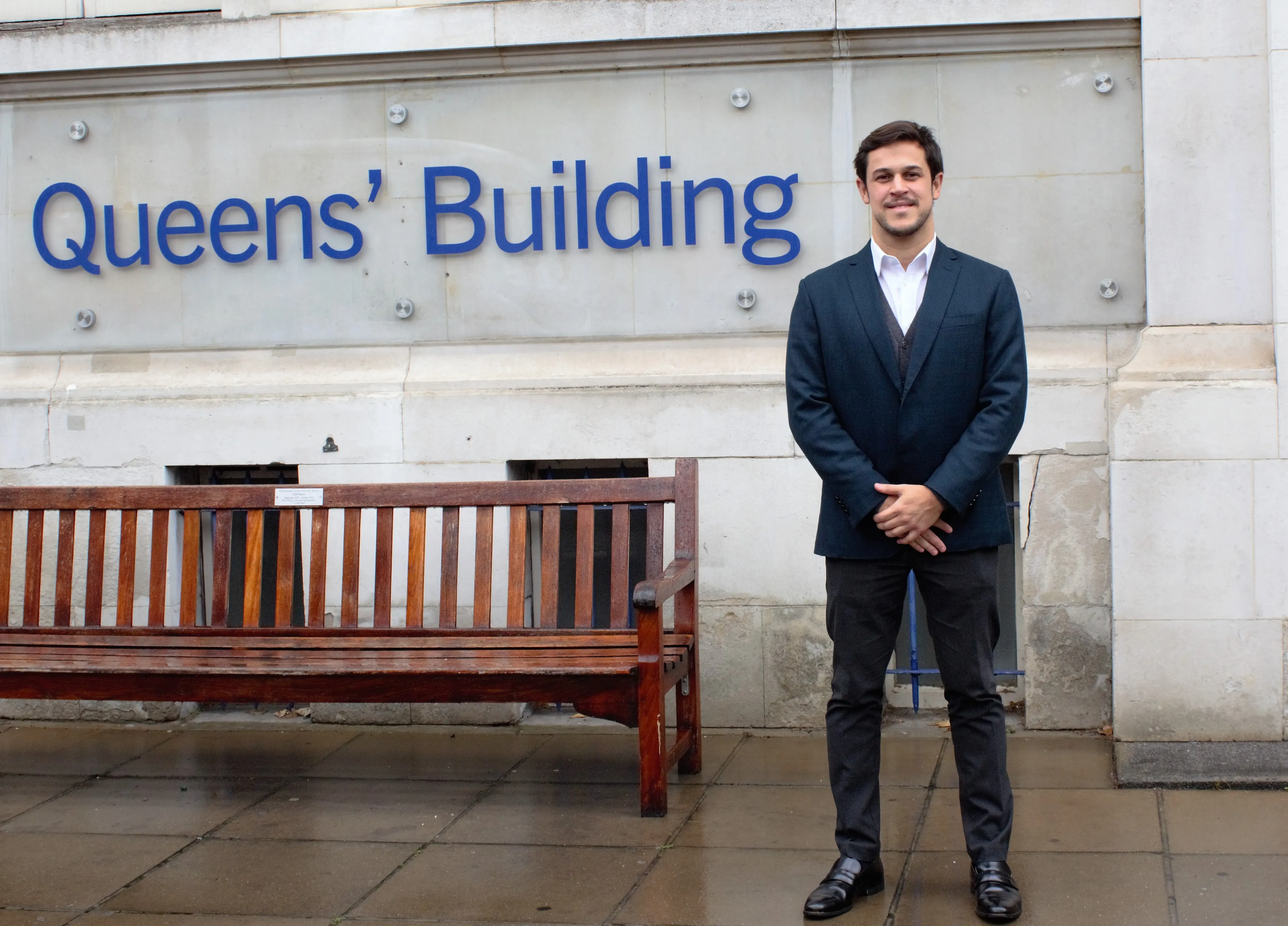 Alumnus Cassio Mosse outside Queens' Building