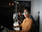 A stock photograph of a woman working in tech