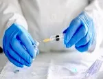 Stock image of a doctor filling an injection syringe with a vaccine