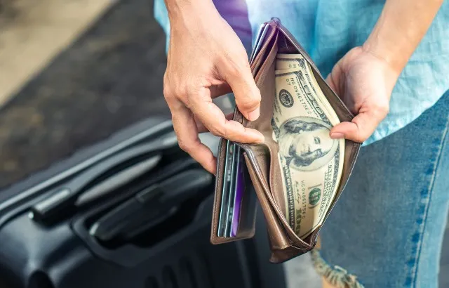 A tourist opening their wallet