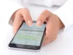 Hands holding a smartphone displaying the WhatsApp messaging application.