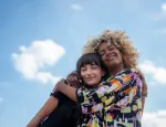 Two people share a warm hug