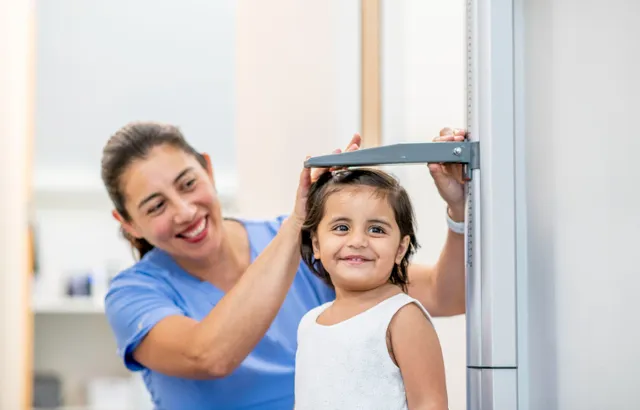 Image of child being measured. Credit: iStock.com.