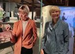 Professor Fran Balkwill standing beside the CanBuild project display at the opening of Cancer Revolution Science, innovation and hope.