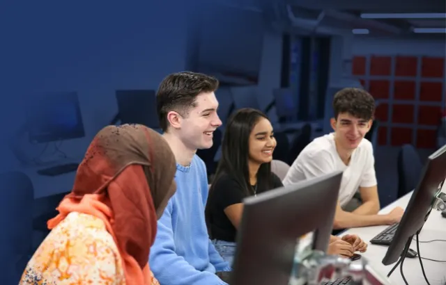 Students sitting around a laptop