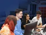 Students sitting around a laptop