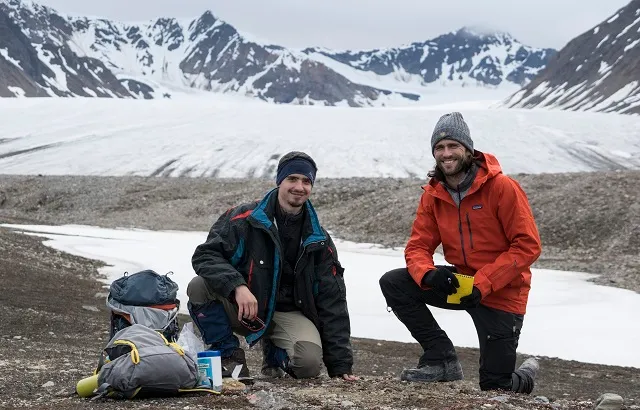 The study’s authors – researchers Juan Carlos Trejos-Espeleta and Dr. James Bradley, at the study site: the forefield of Midtre Lovénbreen glacier, Svalbard. Credit by: James A. Bradley