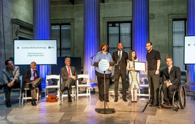 Dr Oussama Metatla accepting the award presented by the President of AT&T New York at the ADA 25th anniversary celebration event