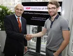 Judge Professor Jim Al-Khalili congratulates Dr Ben Still