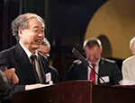 Makoto Kobayashi accepting a copy of the book