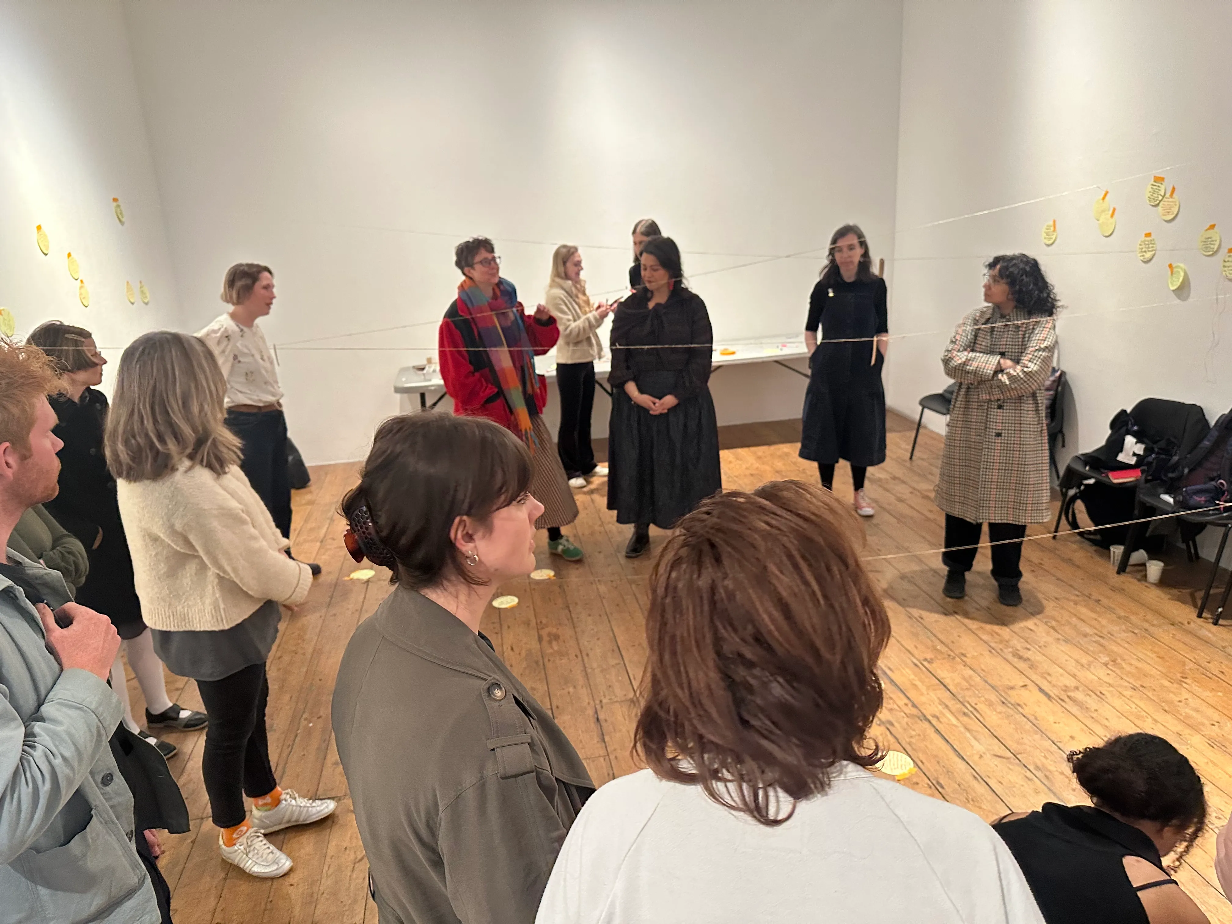 Workshop attendees standing in a room at Bow Arts