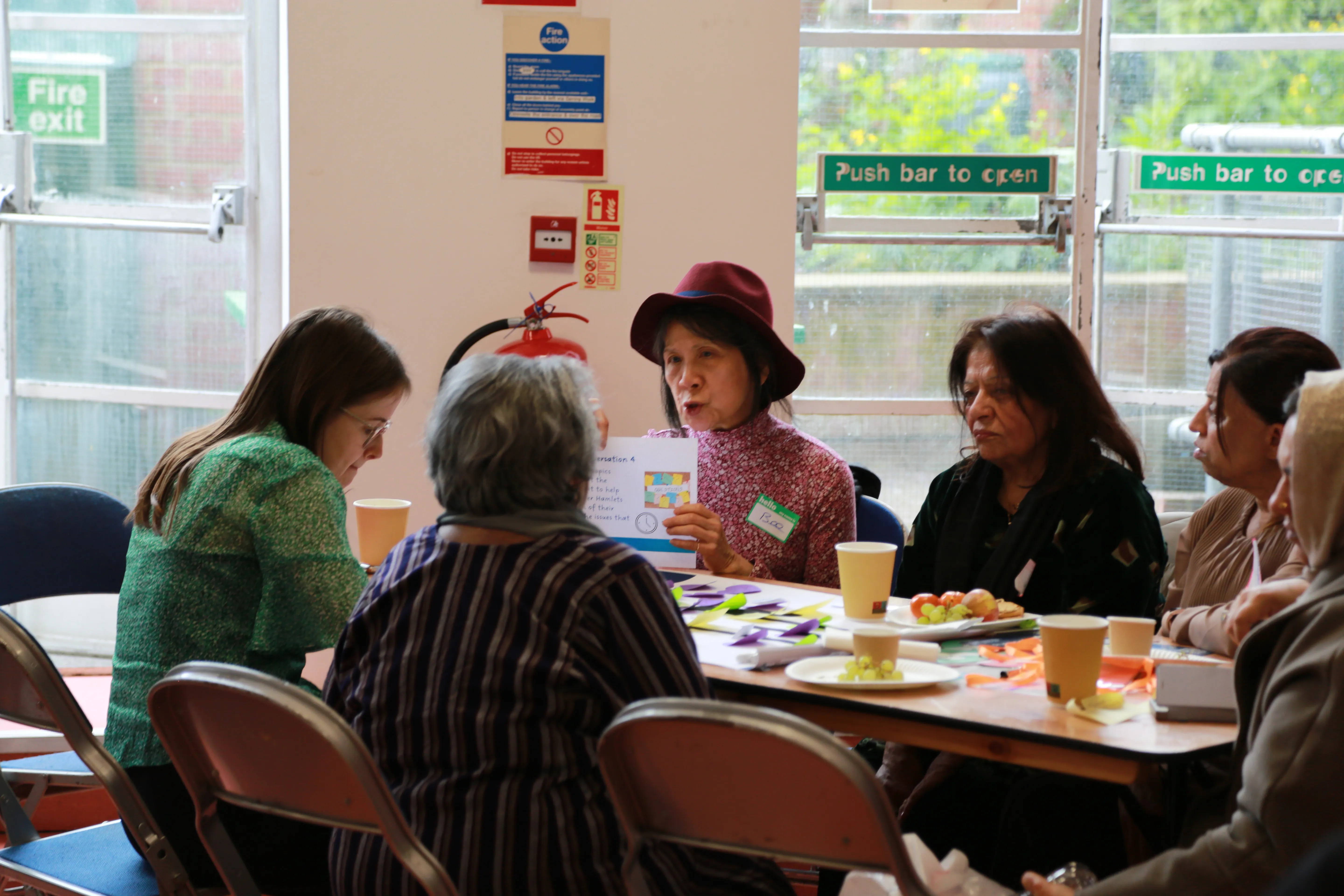 A group of people sitting around a table at a workshop