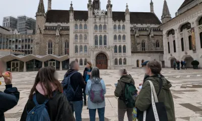 Attendees on the Legends of London walking tour standing outside the Guildhall in London