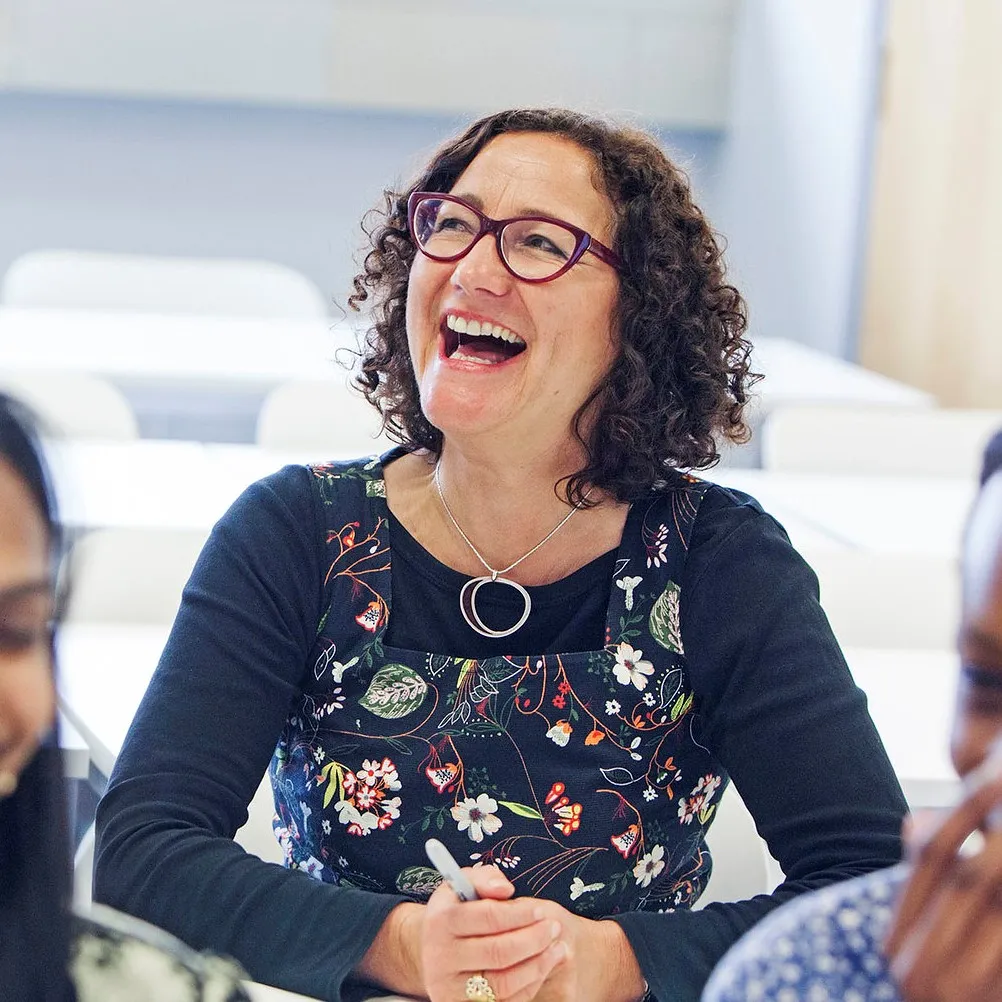 Woman laughing with other people