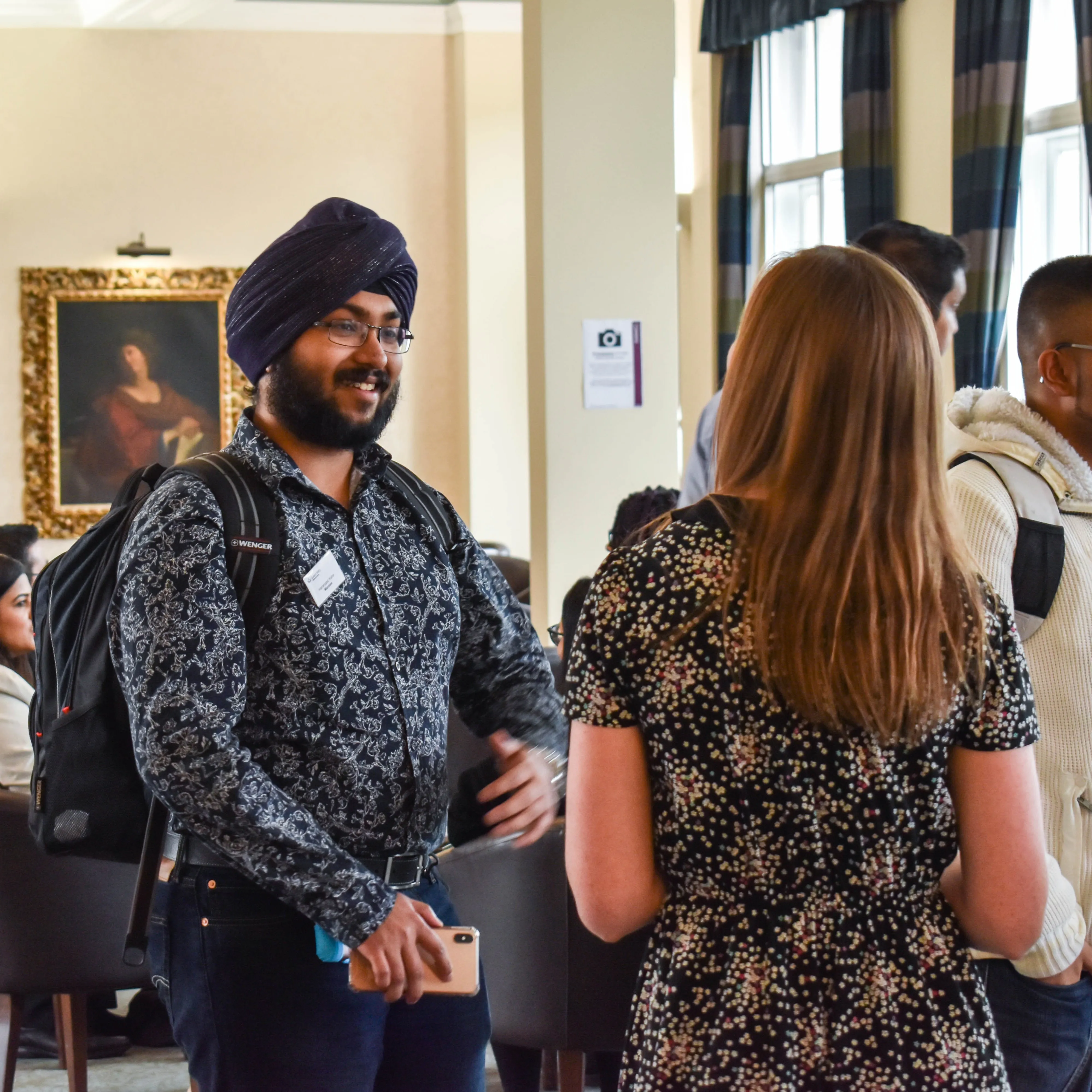 Student talking to member of staff on campus