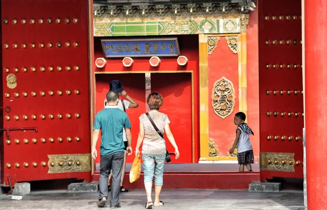 A Chinese couple walking in the street with son
