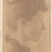 Sepia photograph of a woman in profile clothed in late 19th century dress