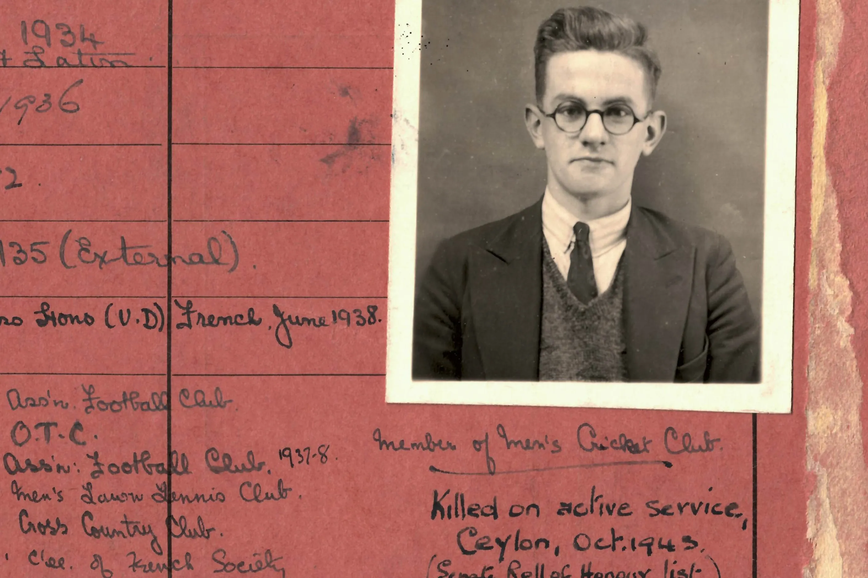 Student card, red, with handwritten text noting 