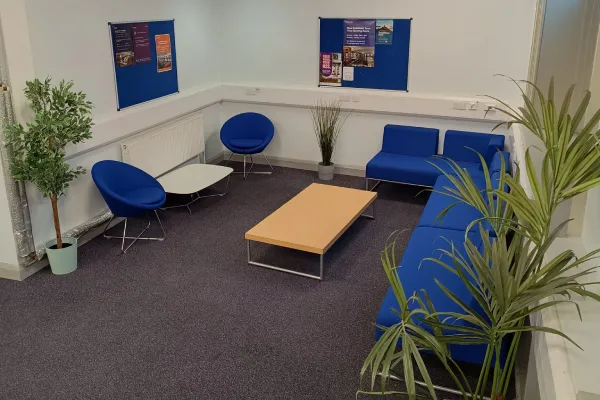 Chairs and coffee table in open seating area of West Smithfield Library basement