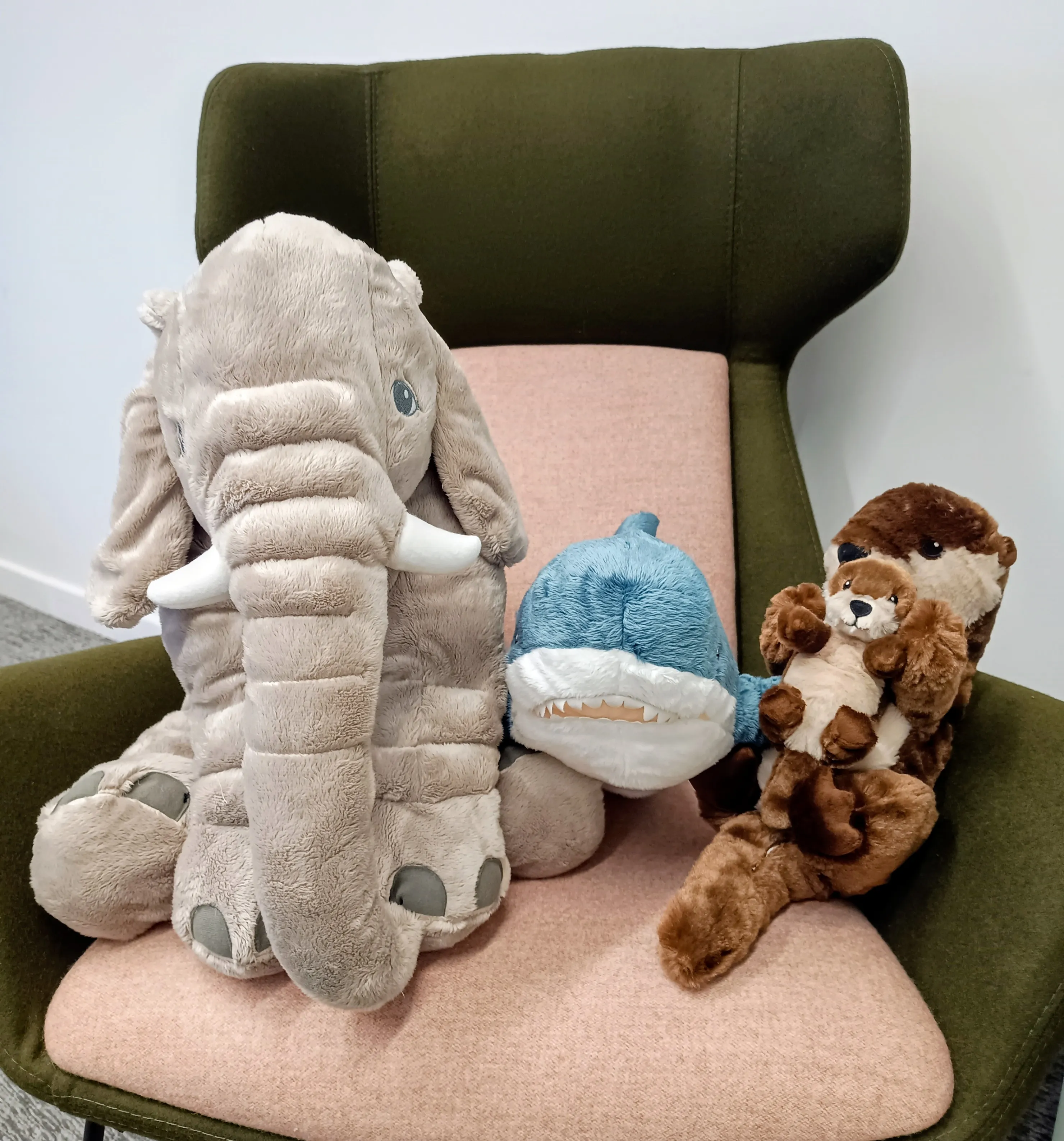 Three stuffed toys in the family room - an elephant, shark and otter