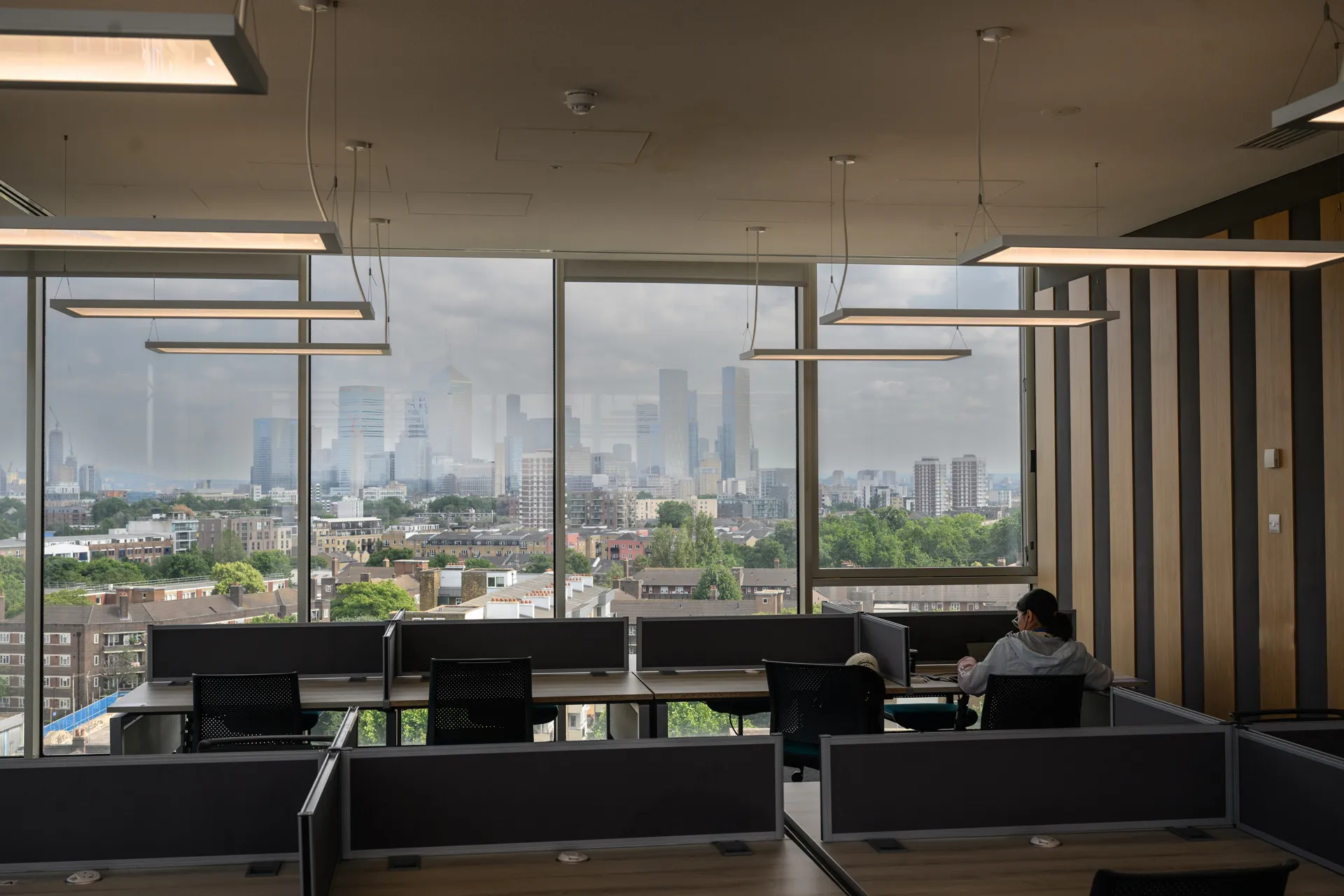 Study desks in reading room with one student studying