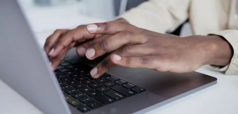 Hands on a laptop
