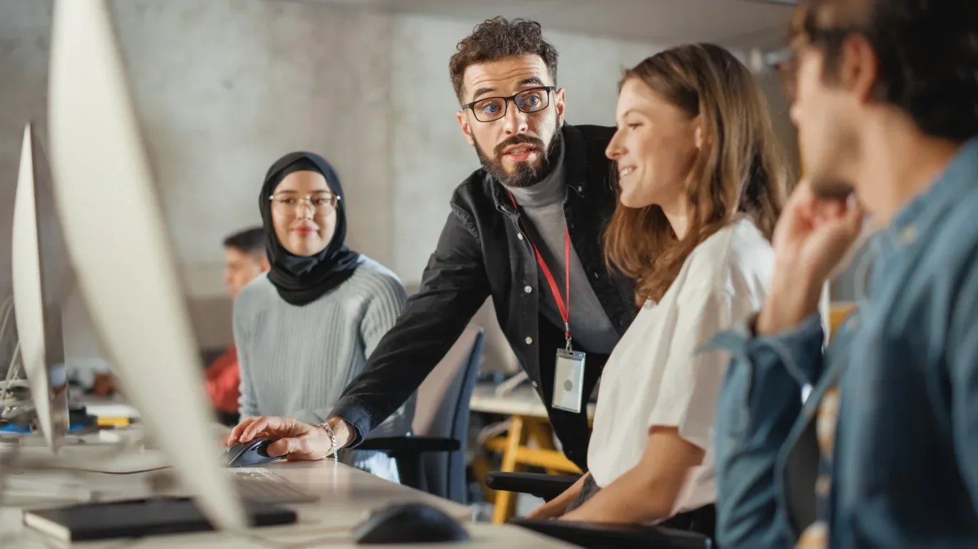 Image of students at a computer screen