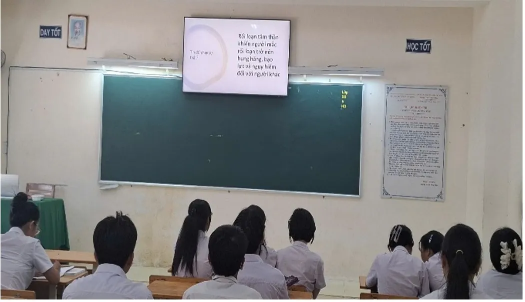 students looking at a board in a classroom in Vietnam
