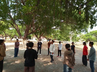 Students standing under a tree