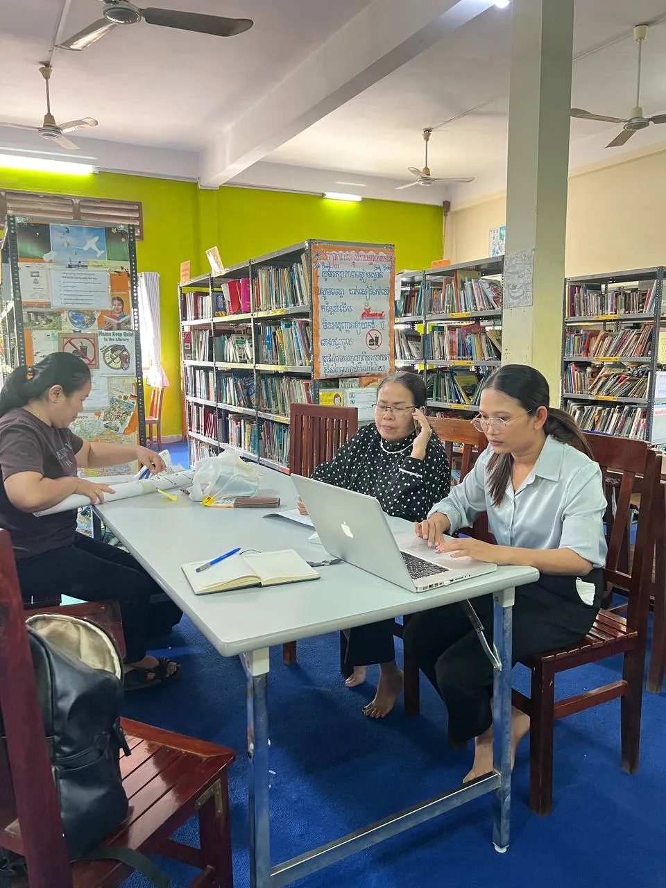 staff working at computers in the library