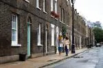 Photo of two women walking down a residential street in front of terraced housing