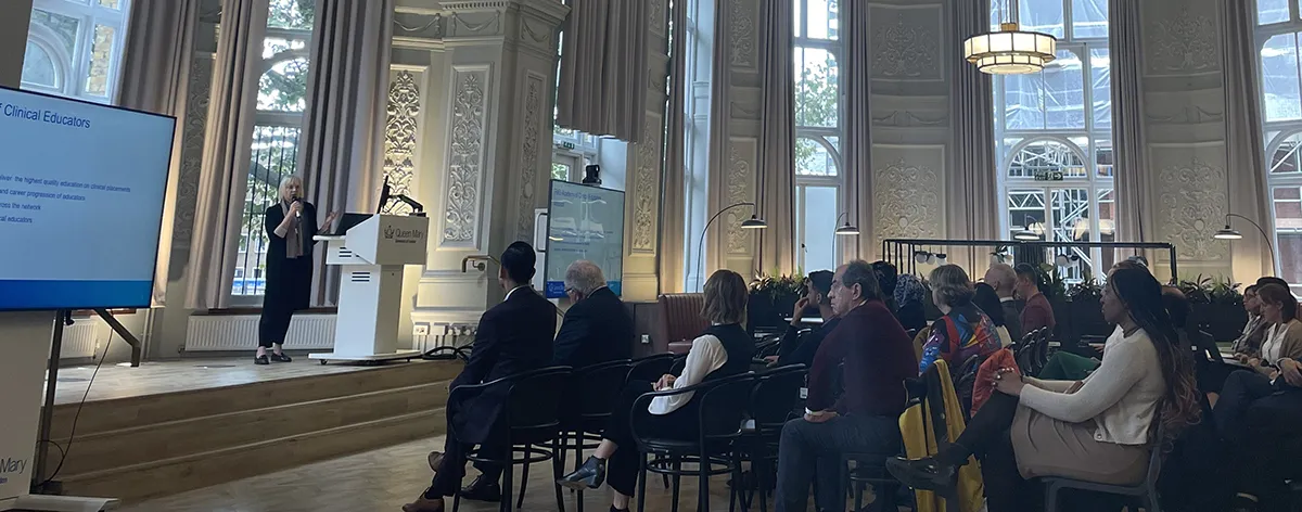 Elspeth giving a lecture at a conference