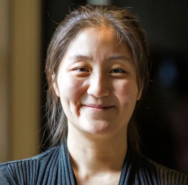 Chelsea Zhang-Anegbeh, Joint Education Institute Administrator, smiling at the camera.
