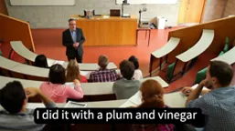 Screen shot of a Lecturer teaching with  dubious closed captions