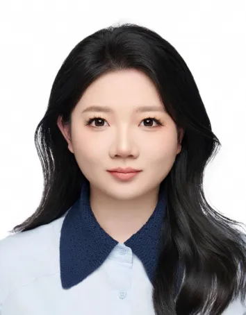 Yuhan is looking directly at the camera. Wearing a white shirt with black collar. White background. Head and shoulders only.