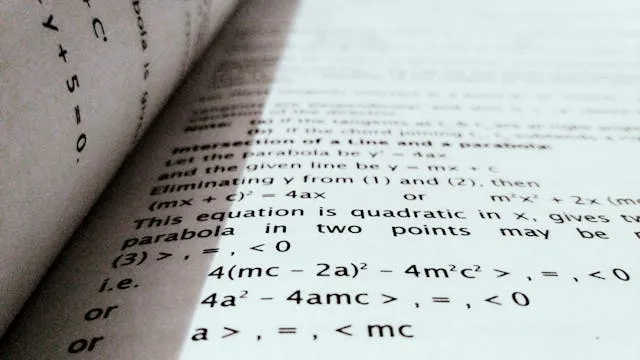 An open textbook displaying mathematical formulas