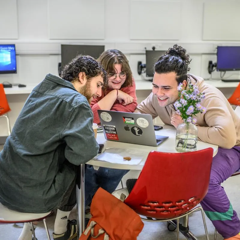 Students sat looking at a laptop