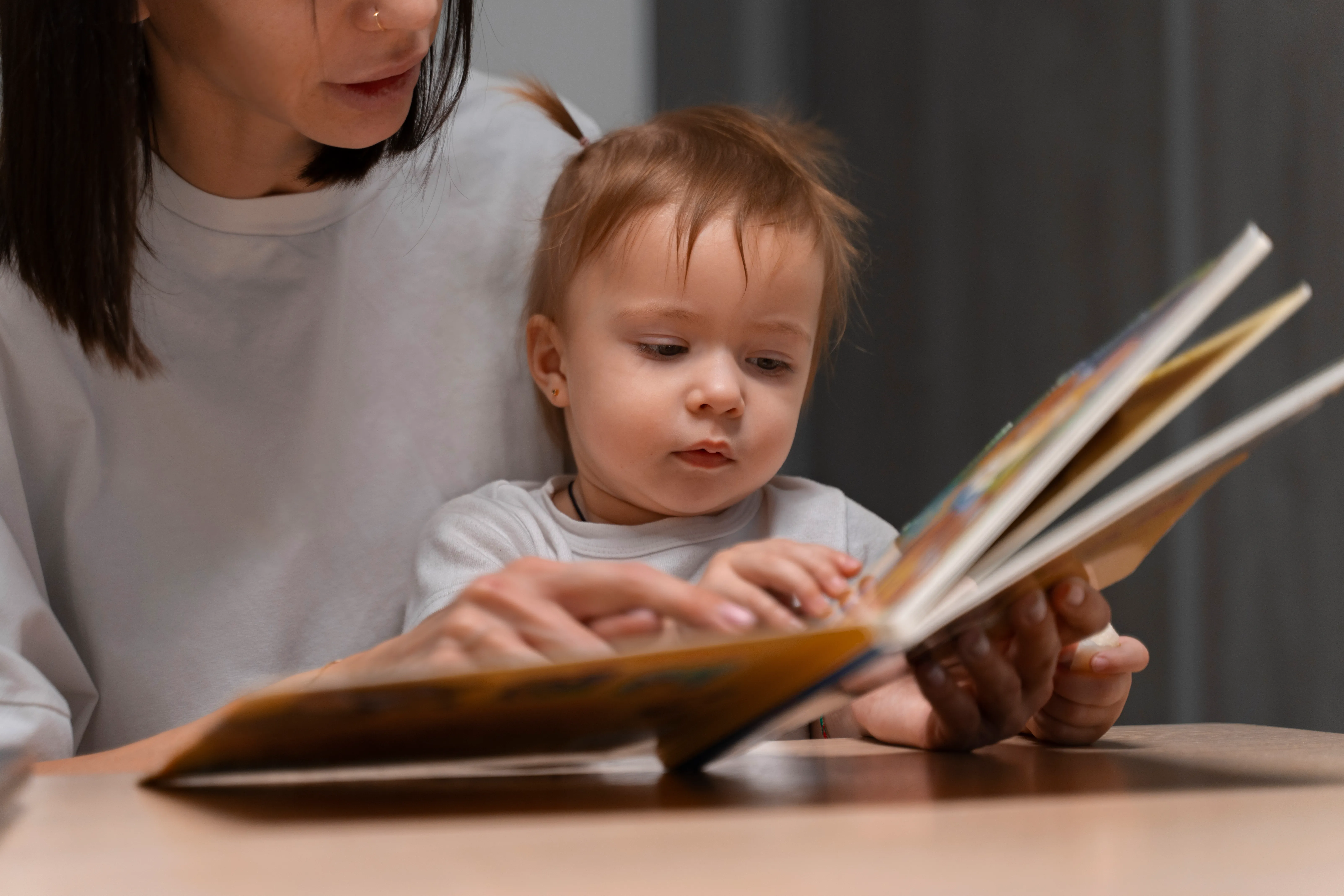A woman reading to an infant