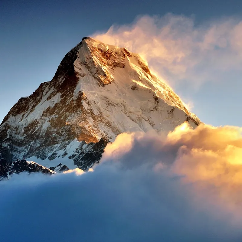 Sunrise over a snow capped Himalayan mountain.