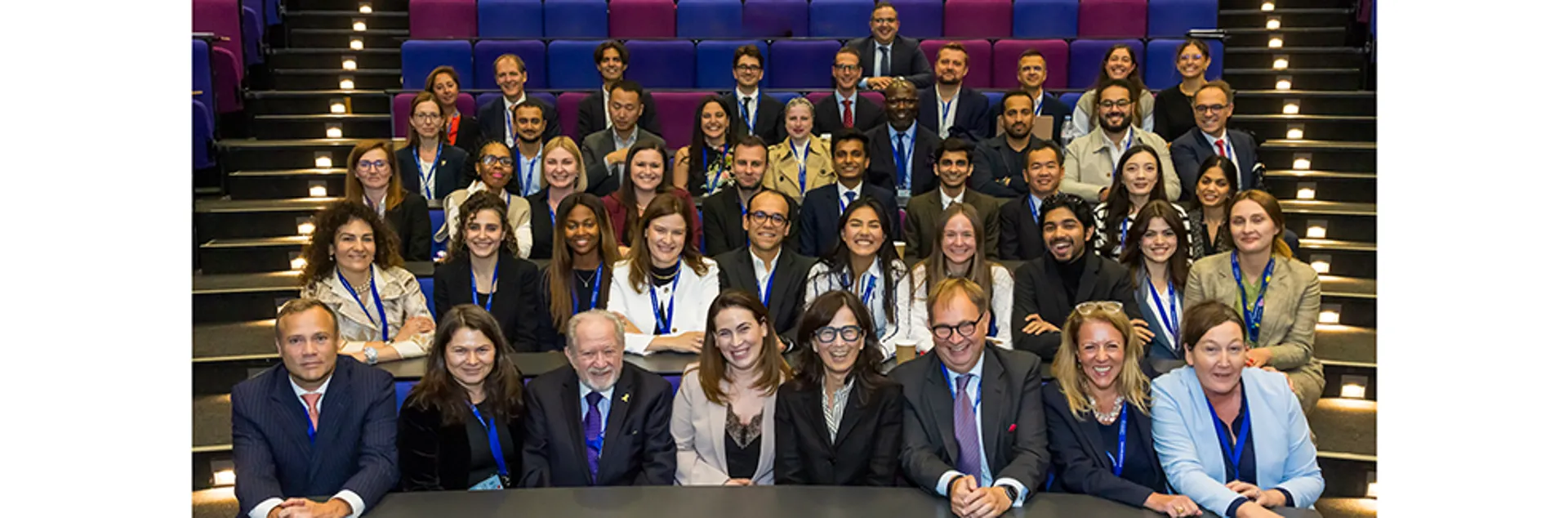 The School of International Arbitration team sat in a lecture theatre for a group photo.