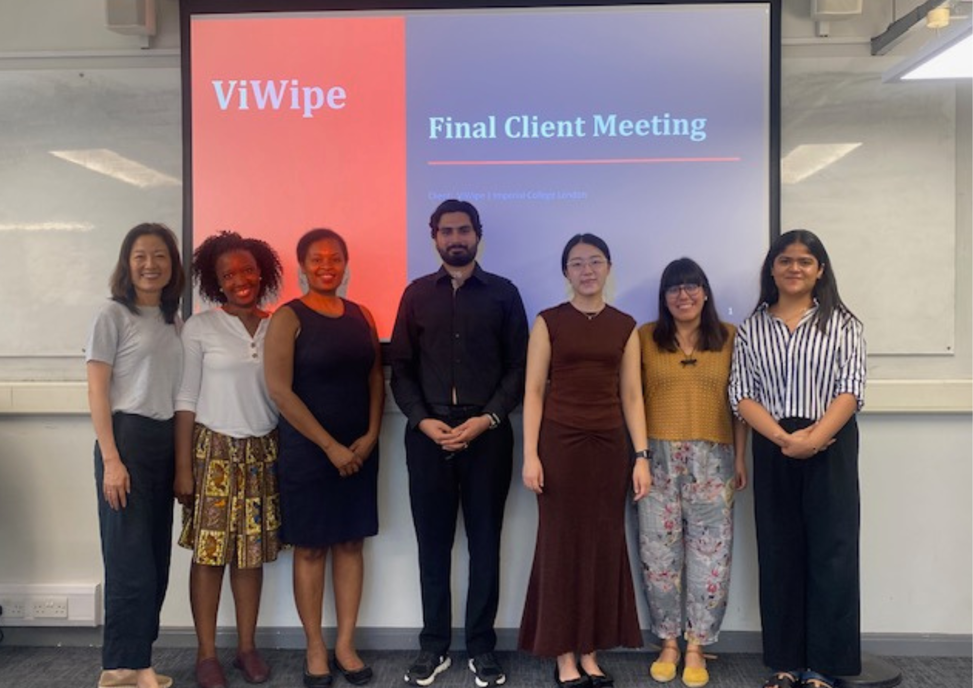 Group photo of students presenting their projects in front of projector