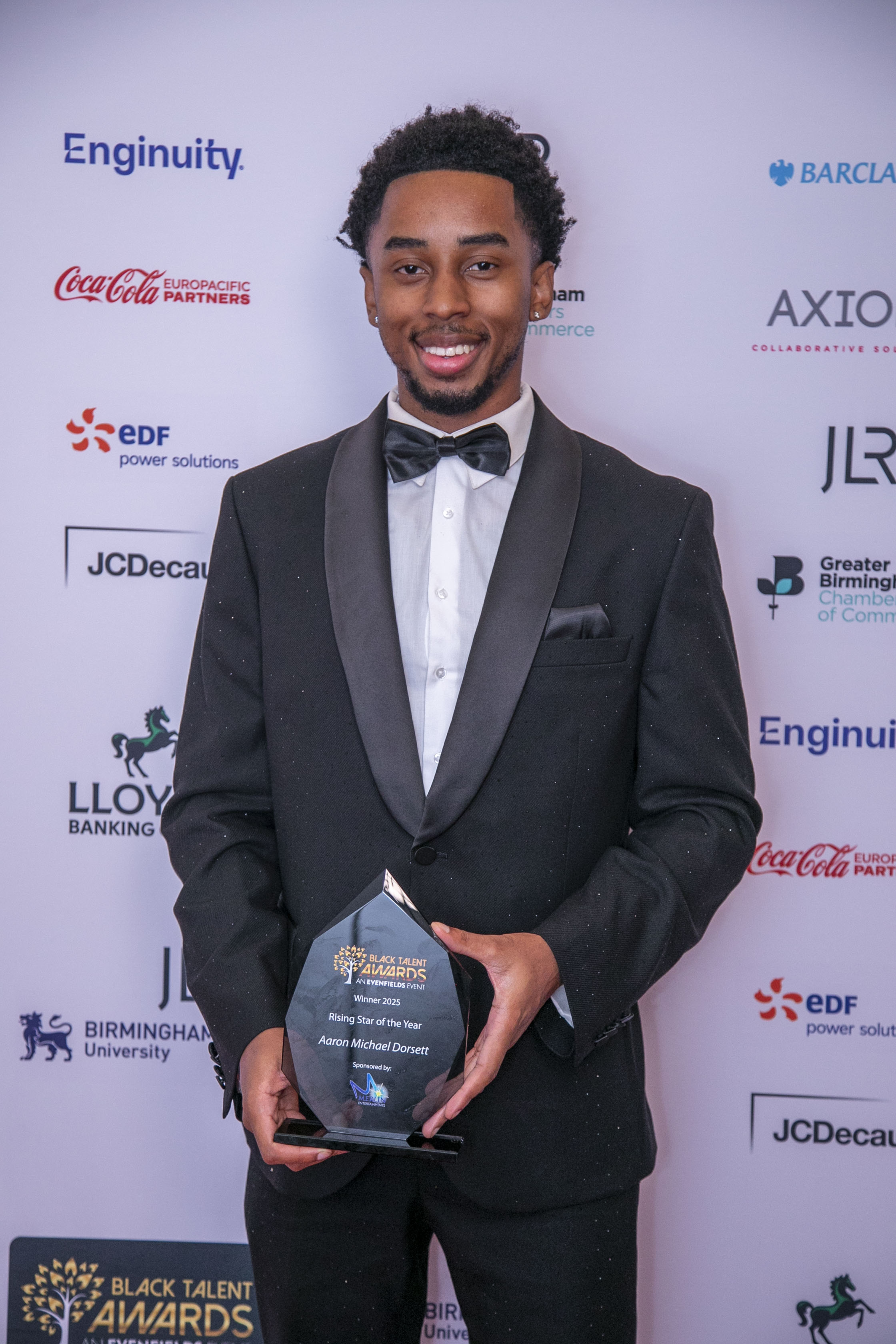 Image of Aaron Michael Dorsett holding the Rising Star of the Year award at the Black Talent Awards 2025