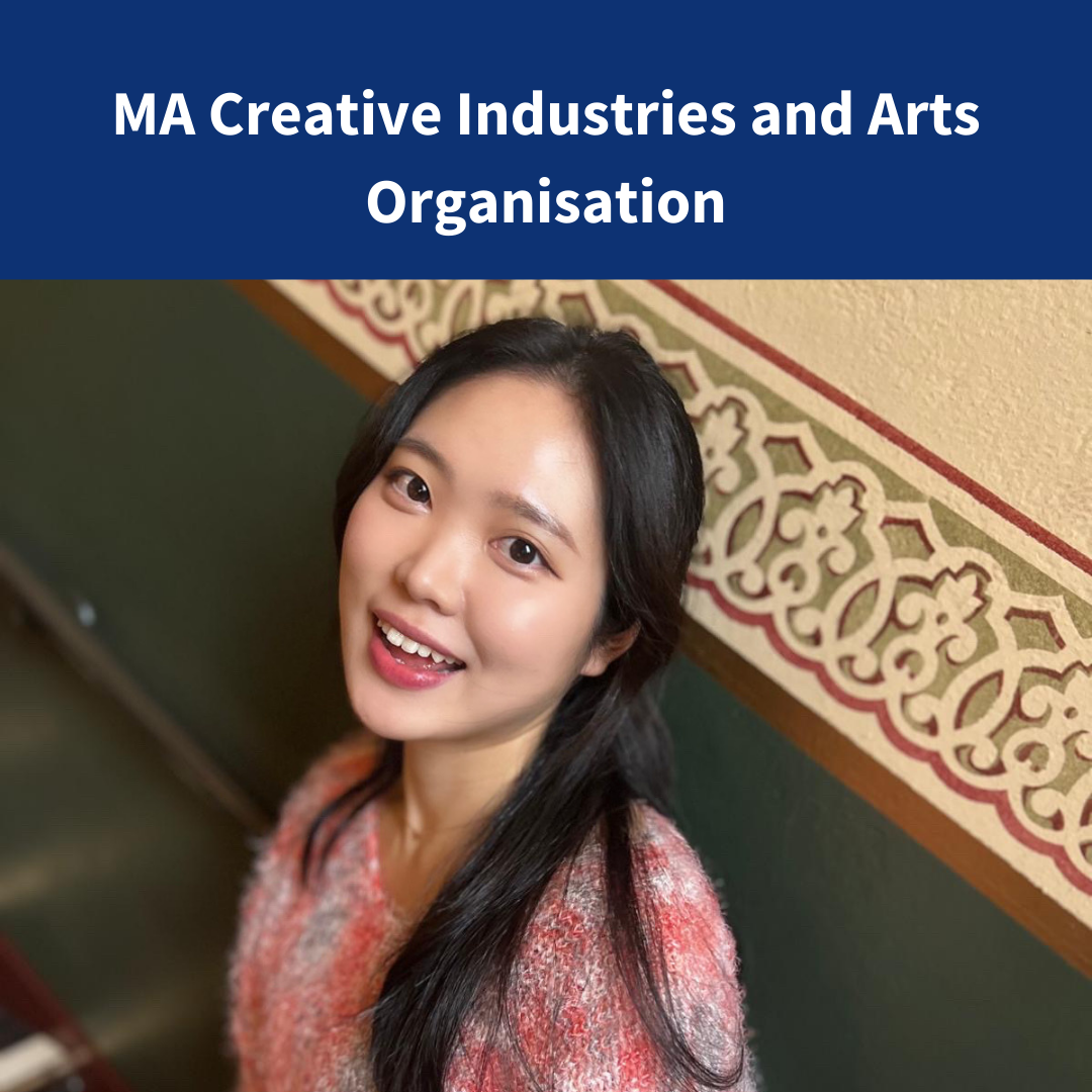 An image of a woman wearing a fluffy jumper standing on a staircase