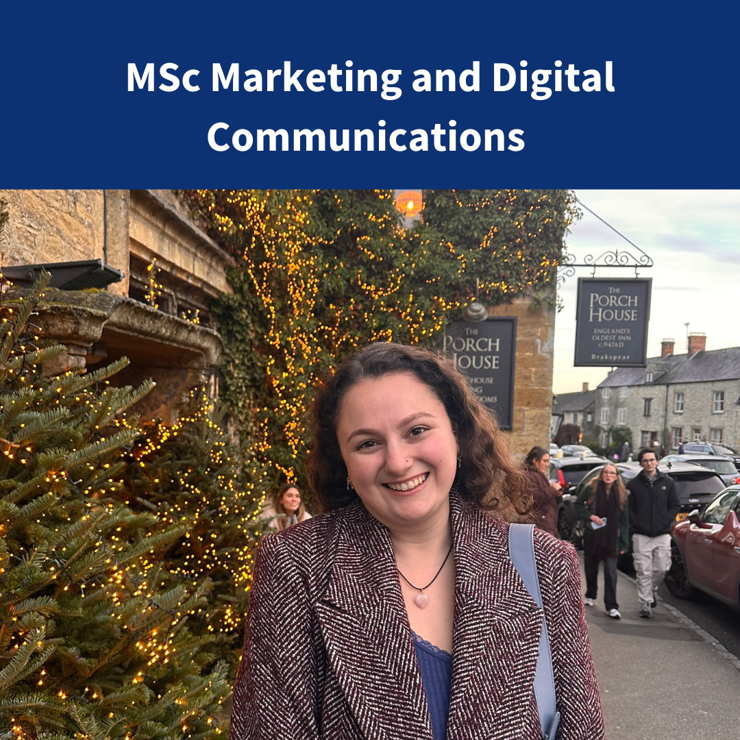 An image of a female student smiling and wearing a smart casual clothes standing in front of an inn next to a christmas tree