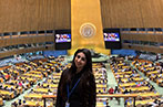 A student standing in front of an auditorium
