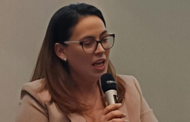 Maria Fanou speaking into a microphone.