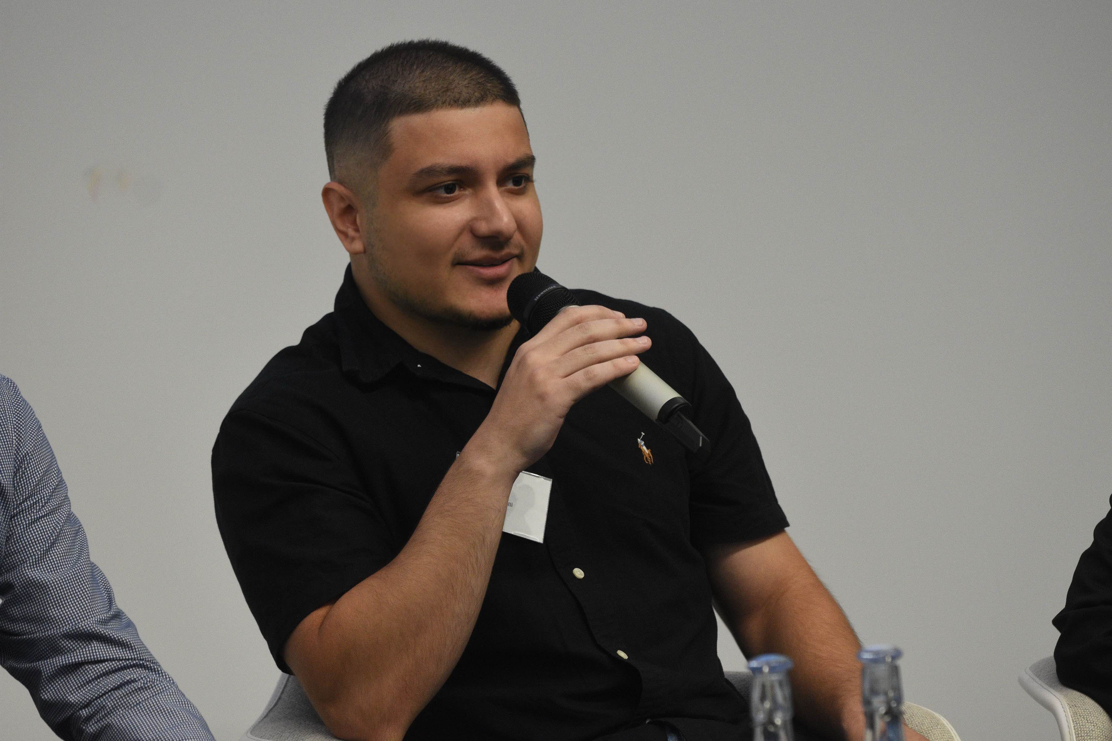 EECS alumni talking in a microphone